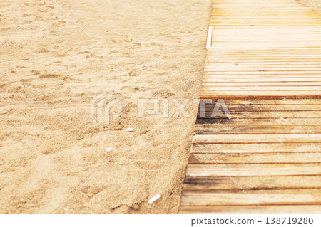 Wooden walkway leading along sandy beach 138719280