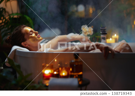 Woman with Gold Mask Enjoying a Luxury Bubble Bath Woman with Gold Mask Enjoying a Luxury Bubble Bath 138719343