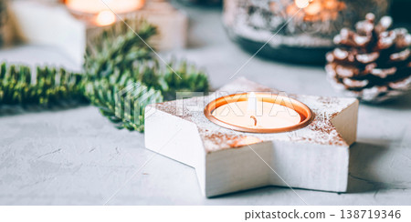Christmas background of candlesticks, fir branches and garland. Christmas background of candlesticks, fir branches and garland. 138719346
