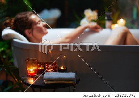 Woman Relaxing in a Pampering Candlelit Bath Woman Relaxing in a Pampering Candlelit Bath 138719372