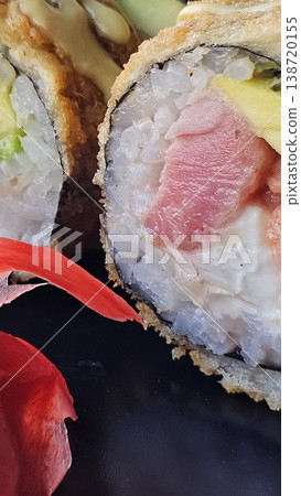 a plate of sushi with tuna, salmon, and avocado rolls, with ginger and wasabi a plate of sushi with tuna, salmon, and avocado rolls, with ginger and wasabi 138720155