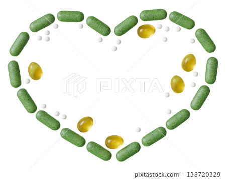 Vitamins and supplements are arranged to form a heart shape on a clear surface. The layout includes green capsules, yellow softgels, and white pills Vitamins and supplements are arranged to form a heart shape on a clear surface. The layout includes green capsules, yellow softgels, and white pills 138720329