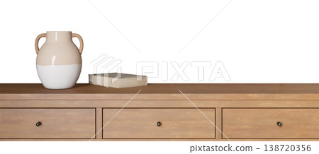 A sideboard features a vase and a book placed on top. The scene displays a clean and tidy setup, ideal for showcasing various home decor ideas 138720356