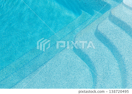 New modern fiberglass plastic swimming pool entrance step with clean fresh refreshing blue water on bright hot summer day at yard or resort hotel spa area. Wooden flooring deck of teak or larch board 138720495