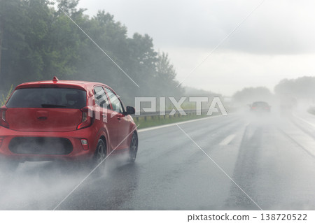 Back tail view of many cars driving fast on wet highway road after rain in Europe. Automobile accident vehicle rush hour collapse. Transportation vacation seasonal stuck. Low visibility bad weather 138720522