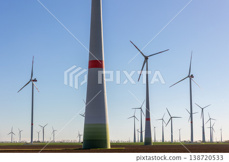 Wind turbines park agricultural field Germany clear blue sky produce renewable electricity. Wind farm landscape sustainability climate energy transition independence during European energy crisis Wind turbines park agricultural field Germany clear blue sky produce renewable electricity. Wind farm landscape sustainability climate energy transition independence during European energy crisis 138720533