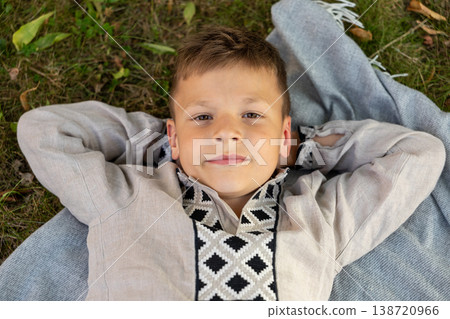 Relaxed Young Boy Lying On Blanket In Park Looking At Camera Summer Lifestyle 138720966