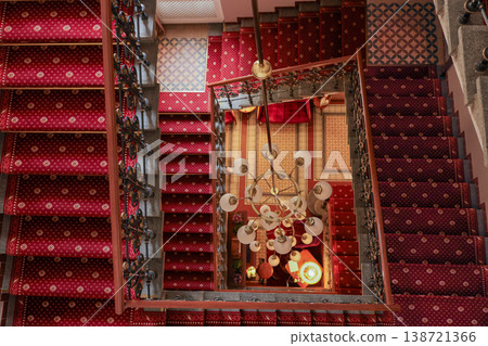 Luxury Red Carpet Spiral Staircase With Chandelier In Elegant Classic Hotel Interior Luxury Red Carpet Spiral Staircase With Chandelier In Elegant Classic Hotel Interior 138721366