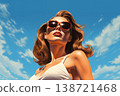 Portrait of a beautiful fashionable woman with a hairstyle and sunglasses, on a blue sky background. Bright day, blue and orange color. Illustration poster in the style of 1960 138721468