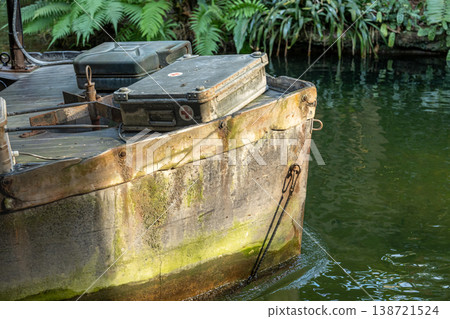 Vintage Boat with Medical Kit on Green Tropical Water in Lush Jungle Setting Vintage Boat with Medical Kit on Green Tropical Water in Lush Jungle Setting 138721524