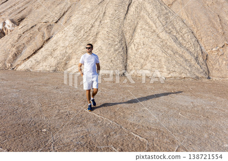 Confident Man Walking On Rocky Landscape Travel Adventure Freedom Concept Confident Man Walking On Rocky Landscape Travel Adventure Freedom Concept 138721554
