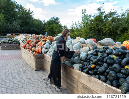 Young Woman Choosing Pumpkin At Autumn Farm Market Harvest Festival Lifestyle Outdoor Scene Young Woman Choosing Pumpkin At Autumn Farm Market Harvest Festival Lifestyle Outdoor Scene 138721559