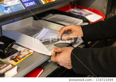 Close Up Of Hands Sorting Mail And Documents At Office Reception Counter Close Up Of Hands Sorting Mail And Documents At Office Reception Counter 138721694