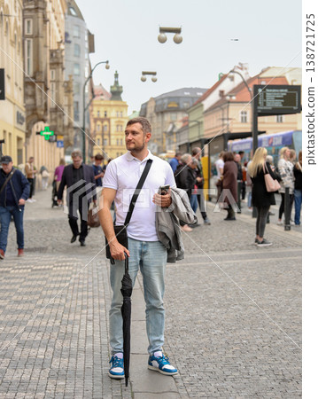 Confident Man Using Smartphone on Busy European City Street with Modern Urban Lifestyle Confident Man Using Smartphone on Busy European City Street with Modern Urban Lifestyle 138721725