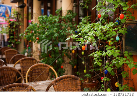Outdoor Cafe Terrace Decorated With Colorful Easter Eggs On Green Branches Spring Holiday Atmosphere Outdoor Cafe Terrace Decorated With Colorful Easter Eggs On Green Branches Spring Holiday Atmosphere 138721738