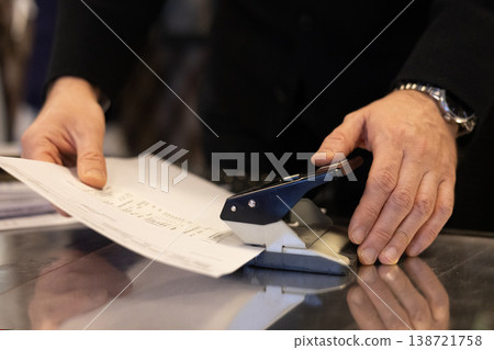 Office Worker Stapling Document Paperwork On Desk Closeup Office Worker Stapling Document Paperwork On Desk Closeup 138721758