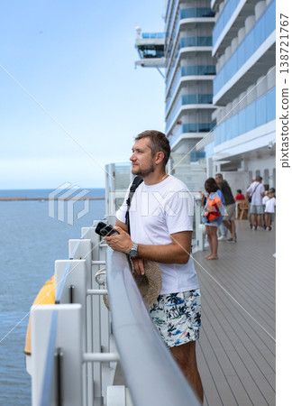 Man Standing on Cruise Ship Deck Looking at Ocean Horizon 138721767