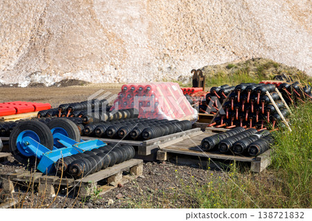 Industrial Conveyor Rollers And Mechanical Parts Stored On Pallets At Construction Equipment Yard 138721832
