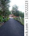 Paved Road Winding Through Green Trees and Lush Nature 138722223