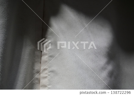 The texture of white fabric bathed in soft natural light 138722296
