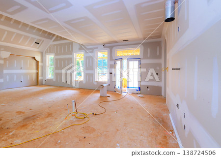 Construction site interior of house with drywall unfinished floor under renovation Construction site interior of house with drywall unfinished floor under renovation 138724506
