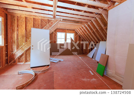 Construction site an unfinished room with wooden beams tools in home renovation project Construction site an unfinished room with wooden beams tools in home renovation project 138724508
