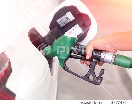 Pumping fuel at a gas station, close-up shot. Pumping fuel at a gas station, close-up shot. 138724863