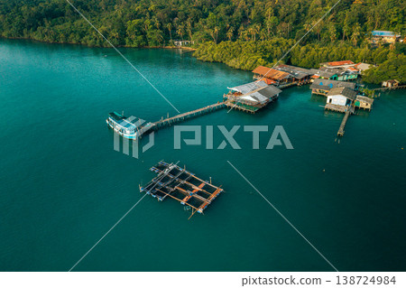 Aerial landscape of a traditional coastal fishing village with stilt houses and aquaculture Aerial landscape of a traditional coastal fishing village with stilt houses and aquaculture 138724984