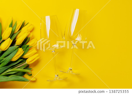 White wine glasses with yellow tulips 138725355