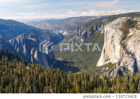 Mountain landscape in Yosemite National Park with towering granite cliffs, green forests Mountain landscape in Yosemite National Park with towering granite cliffs, green forests 138725428