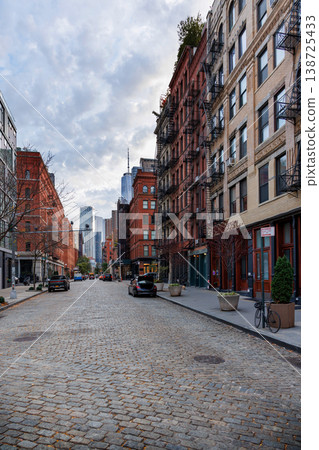 Captivating view of a bustling NYC Downtown street framed by iconic Manhattan skyscrapers Captivating view of a bustling NYC Downtown street framed by iconic Manhattan skyscrapers 138725433