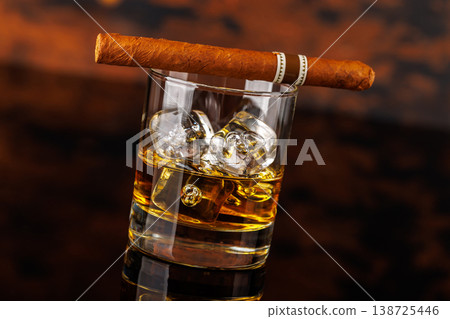 Glass of whiskey with ice and cigar 138725446