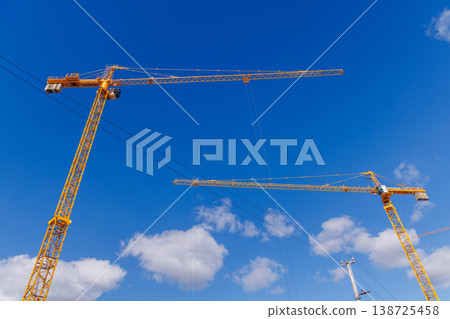 Construction cranes against blue sky Construction cranes against blue sky 138725458