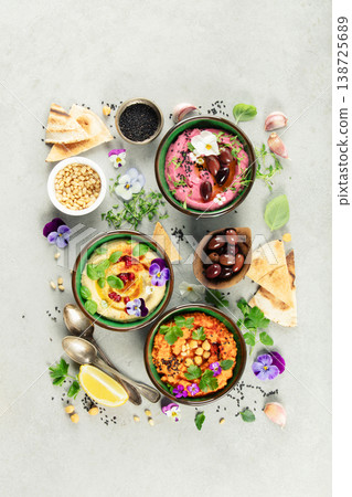 Gourmet Hummus Trio with Fresh Ingredients and Edible Flowers Gourmet Hummus Trio with Fresh Ingredients and Edible Flowers 138725689