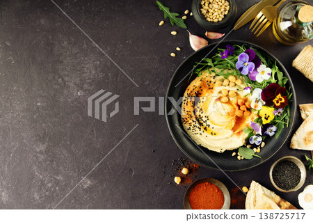 Gourmet Hummus with Edible Flowers and Spices on Dark Background Gourmet Hummus with Edible Flowers and Spices on Dark Background 138725717