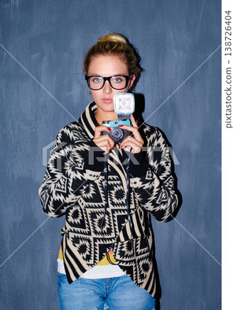 Woman, portrait and retro camera on blue background for aesthetic, shooting or creative image. Photographer, person or girl and face with vintage, picture and serious for memory on mock up space Woman, portrait and retro camera on blue background for aesthetic, shooting or creative image. Photographer, person or girl and face with vintage, picture and serious for memory on mock up space 138726404
