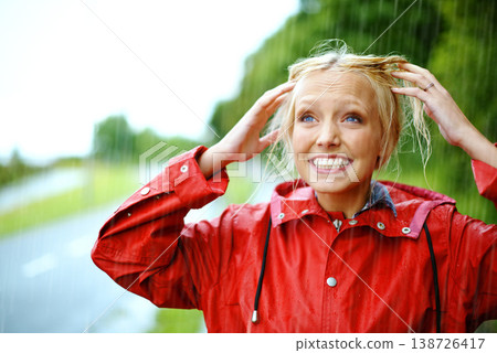 Woman, smile and raincoat or hands in storm, wet and cold from weather, winter and nature. Happy female person, fashion and red jacket is trendy, rainfall and protection from water, face and playful 138726417
