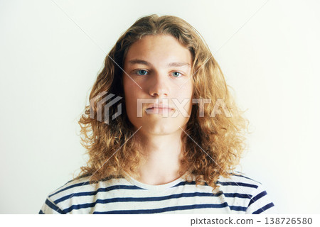 Long hair, man or fashion for portrait in a studio with hipster style clothing or shirt on white background. Face, person or headshot of young stylish gen z male model with cool confidence and pride 138726580