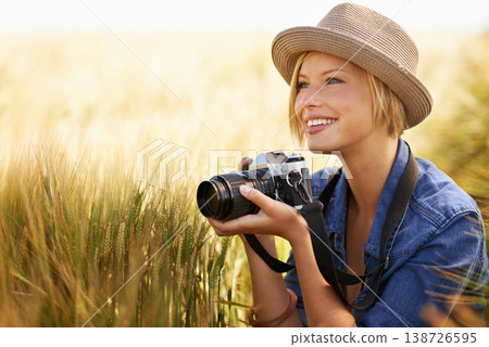 Field, smile and woman with a camera, photographer and sunshine with tourism, travelling and nature. Person, photography or girl with summer, thinking or countryside with picture, freedom or creative 138726595
