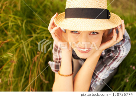 Portrait, hat and young woman in nature with a straw accessory sitting in an outdoor garden for fresh air. Happy, fashion and female person from Australia in forest, woods or field with casual style. Portrait, hat and young woman in nature with a straw accessory sitting in an outdoor garden for fresh air. Happy, fashion and female person from Australia in forest, woods or field with casual style. 138726774
