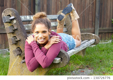 Portrait, woman and smile for laying on bench in park, field or backyard for relax, peace or young. Face, person and happiness outdoor in garden, lawn or seat for weekend, vacation or holiday Portrait, woman and smile for laying on bench in park, field or backyard for relax, peace or young. Face, person and happiness outdoor in garden, lawn or seat for weekend, vacation or holiday 138726776