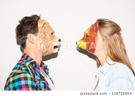 Animal mask, party and a couple on a white background for fun, bonding or comedy. Funny, character and a man and woman with equipment for a comic date, social or at a halloween event together Animal mask, party and a couple on a white background for fun, bonding or comedy. Funny, character and a man and woman with equipment for a comic date, social or at a halloween event together 138726864