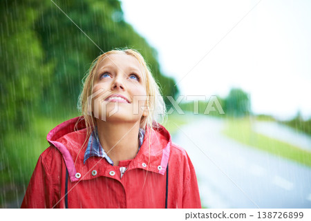 Woman, smile and raincoat in outdoor rainfall, wet and cold from weather, winter and nature. Happy female person, fashion and red jacket is cool, rain and looking up to sky by water, face and holiday Woman, smile and raincoat in outdoor rainfall, wet and cold from weather, winter and nature. Happy female person, fashion and red jacket is cool, rain and looking up to sky by water, face and holiday 138726899