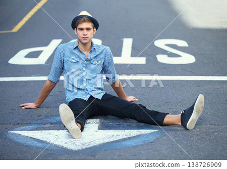 Man, arrow and symbol or sign on road, direction and guide to future, growth and opportunity. Male person, street and fashion on asphalt, casual and cool for outdoor, pavement and icon in city Man, arrow and symbol or sign on road, direction and guide to future, growth and opportunity. Male person, street and fashion on asphalt, casual and cool for outdoor, pavement and icon in city 138726909