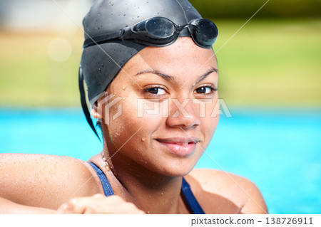 Portrait, happy woman and face of athlete swimming in sunshine for challenge, underwater sports and training. Smile, swimmer and pool for performance, exercise and outdoor for triathlon competition 138726911