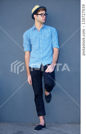 Man, profile or trendy fashion by wall background to relax on break with cool style, swag or elegant outfit. Hipster full body, edgy person or confident model in urban clothes, glasses or fedora hat Man, profile or trendy fashion by wall background to relax on break with cool style, swag or elegant outfit. Hipster full body, edgy person or confident model in urban clothes, glasses or fedora hat 138727039