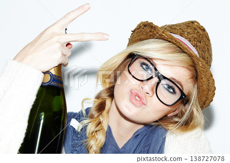 Woman, face and portrait with champagne or peace sign of nerd, geek or hipster against a studio background. Attractive female person with glasses, nerdy or fashion style holding bottle of alcohol Woman, face and portrait with champagne or peace sign of nerd, geek or hipster against a studio background. Attractive female person with glasses, nerdy or fashion style holding bottle of alcohol 138727078