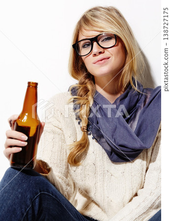 Woman, portrait and relax with beer or drink of nerd, geek or hipster on a studio white background. Attractive young female person or model with glasses, cool or fashion style holding alcohol bottle Woman, portrait and relax with beer or drink of nerd, geek or hipster on a studio white background. Attractive young female person or model with glasses, cool or fashion style holding alcohol bottle 138727175