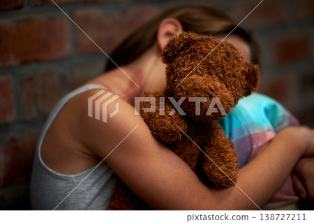 Abuse, girl and child with fear, teddy bear and stress with depression, anxiety and bullying. Person, kid and victim with a toy, home and sad with mental health, crisis and trauma with development 138727211