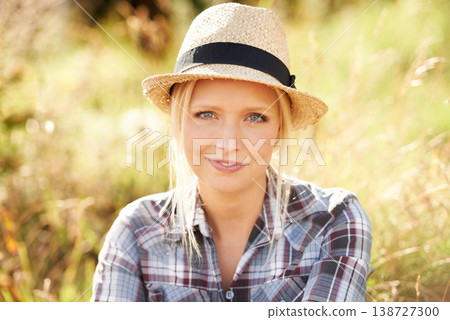 Happy, portrait and young woman in nature with a straw hat sitting in an outdoor garden for fresh air. Smile, fashion and female person from Australia in the forest, woods or field with casual style. 138727300
